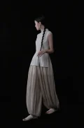 Full side silhouette of a beige pinstripe cheongsam collar top, showcasing the elegant tailored cut, side slit detail, and classic high mandarin collar of this cheongsam style top.