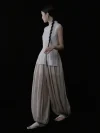 Full side silhouette of a beige pinstripe cheongsam collar top, showcasing the elegant tailored cut, side slit detail, and classic high mandarin collar of this cheongsam style top.