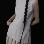 Beige pinstripe chinese cheongsam top with classic cheongsam collar, sleeveless design, and side slit detail, a minimalist cheongsam style top for daily and formal wear.