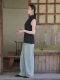 Full side silhouette view of a black pinstripe qipao top, with a high mandarin collar and sleek sleeveless design, a refined top qipao for both casual and formal events.