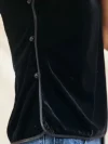Close-up of traditional buttons on black sleeveless velvet mandarin collar qipao style blouse
