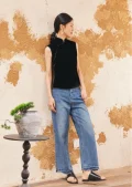 Model wearing black sleeveless velvet mandarin collar qipao style blouse, paired with jeans for casual chic look