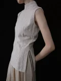 Close up of the side tailoring detail on a cheongsam collar top, showcasing the structured fit, side slit, and premium pinstripe fabric of this minimalist chinese cheongsam top.