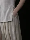 Close up of the side pocket and slit detail on a chinese cheongsam top, featuring a soft pinstripe fabric and classic cheongsam collar design for both style and functionality.