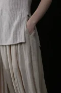 Close up of the side pocket and slit detail on a chinese cheongsam top, featuring a soft pinstripe fabric and classic cheongsam collar design for both style and functionality.