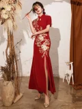 Chinese qipao wedding dress in a styled pose with a rose, showcasing premium floral embroidery and a sleek high-slit design for bridal photoshoots and receptions.