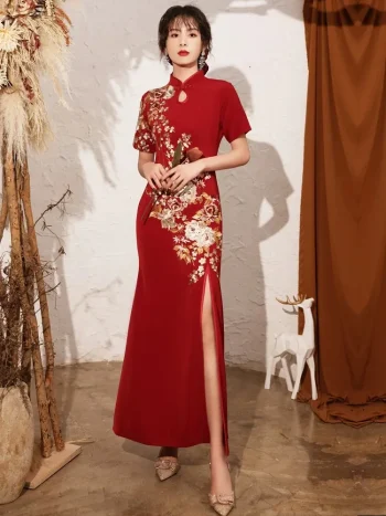 Chinese red wedding qipao full view, featuring elegant floral embroidery, high slit skirt, and form-fitting silhouette for modern bridal wear.