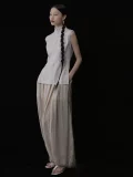 Full body side view of a chinese cheongsam top with functional side pockets, classic cheongsam collar, and sleeveless pinstripe design, paired with loose wide leg pants for a casual elegant look.