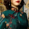 Close-up of red frog buttons on Old Shanghai cheongsam with green floral print