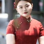 Close-up of plus size red long cheongsam, showing mandarin collar with pearl buttons for curvy women