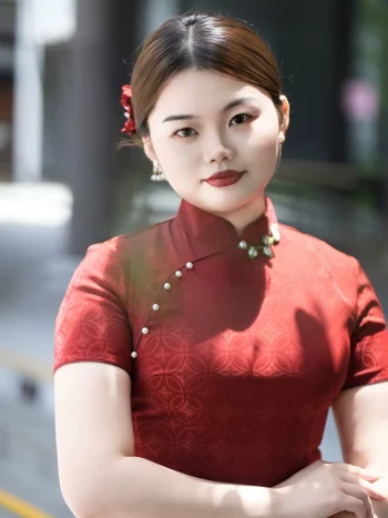 Close-up of plus size red long cheongsam, showing mandarin collar with pearl buttons for curvy women
