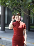 Plus size red long cheongsam in outdoor setting, full-length elegant qipao for curvy women