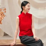 Woman sitting in red cheongsam style blouse, sleeveless modern chinese cheongsam top