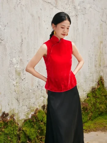 Woman standing in red chinese cheongsam blouse, modern cheongsam style sleeveless top