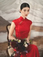 Full body couple wedding portrait, bride in red long train wedding cheongsam (qipao) leaning on vintage wooden cabinet, classic chinese bridal dress for wedding ceremony