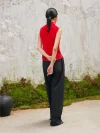 Back view of woman in red sleeveless modern cheongsam blouse, featuring chinese cheongsam style velvet fabric