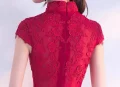 Close up of the back lace and zipper detail on a red qipao wedding dress, featuring ornate floral lace embroidery and a seamless hidden zipper for a polished bridal look.