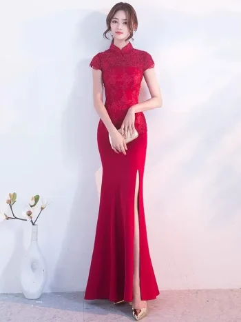 Elegant red wedding qipao with intricate lace bodice, high slit skirt, and classic mandarin collar, a premium choice for modern brides seeking traditional Chinese bridal style.