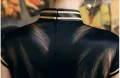 Back view of a shanghai cheongsam dress with vintage design, featuring a high mandarin collar with gold trim, hidden back zipper, and smooth silk-like fabric, showcasing classic old shanghai craftsmanship.