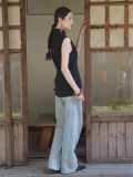 Side view of a sleeveless chinese qipao top paired with casual jeans, showcasing the elegant form-fitting silhouette and classic mandarin collar of this black qipao top.