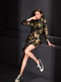 Trendy cheongsam dress short in black with all-over tiger print, featuring a high mandarin collar and mini silhouette, styled casually with sneakers for a modern streetwear aesthetic.