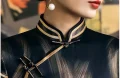 Close-up of a cheongsam vintage mandarin collar, showcasing traditional handcrafted frog buttons with gold piping trim, a signature design element of classic cheongsam shanghai style.