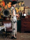 Back view of woman in 1920s Shanghai Chinese silk cheongsam, showcasing ink-wash print, black lace trim, high slit, and elegant vintage styling with heels.