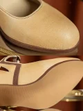Close-up of 1920s vintage beige genuine leather qipao Mary Jane shoes, highlighting soft leather texture and neat brown contrast trim stitching.