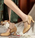 Woman wearing 1920s vintage beige genuine leather qipao Mary Jane shoes with brown contrast trim, paired with a retro green floral qipao dress.