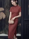 Women's 1940s traditional red plaid qipao dress, a classic red qipao featuring a subtle checkered pattern in deep red, short sleeves, stand-up collar with frog buttons, and a high slit. The model poses indoors holding a gold clutch, highlighting the elegant vintage silhouette and timeless appeal of this traditional Chinese dress.