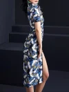 Back side view of a woman wearing a blue crane print midi cheongsam dress, showcasing the clean back silhouette, detailed crane and floral print, and the tailored fit of this elegant midi cheongsam.