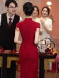 Back view of a wine red floral lace wedding cheongsam dress, showing the elegant silhouette and hidden zipper design of this midi cheongsam, styled for traditional chinese weddings.