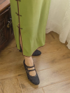 Side view of black 1920s replica qipao shoes with green qipao, Republic of China vintage jacquard leather kitten heel cheongsam shoes