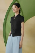 Side profile shot of a black chinese mandarin collar frog buttons qipao top, a form-fitting modern qipao inspired top showing the traditional button placket and side ruching detail.