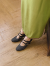 Black floral jacquard leather qipao kitten heel shoes in everyday wear look, Republic of China vintage mary jane style with double cutout straps, paired with long green cheongsam dress for casual traditional style
