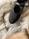 Closeup of black floral jacquard qipao shoes, Republic of China vintage mary jane style cheongsam shoes with single strap design
