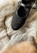 Closeup of black floral jacquard qipao shoes, Republic of China vintage mary jane style cheongsam shoes with single strap design