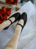 Black leather Mary Jane qipao shoes styled with sheer white floral print stockings, highlighting the elegant rose pattern and classic brogue shoe details for a vintage aesthetic