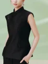 Side profile view of a women's black cheongsam top, a tailored sleeveless qipao style mandarin collar top with functional side pockets, worn by a model in a studio setting.