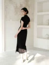 Back view of a woman wearing a black qipao dress, showing the elegant silhouette and high side slit. This women qipao blends traditional style with modern tailoring for a flattering fit.