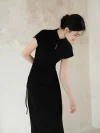 Close up of a woman in a black qipao dress, showing the waist drawstring detail that creates a tailored slimming effect. This women qipao blends modern design with traditional elements.