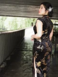 Back view of the Chinese Black Sleeveless Plus Size Cheongsam Qipao Dress, showcasing the tailored fit and side slit design of this qipao black dress. The elegant silhouette and detailed print of this cheongsam qipao plus size are highlighted from the back, emphasizing its flattering style for all body types.