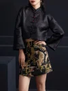Front view shot of the ink black tiger jacquard high waist A-line short skirt paired with a black cropped Chinese jacket, emphasizing the skirt's bold tiger print and high waist; statement black mini skirt for modern Chinese-inspired outfits