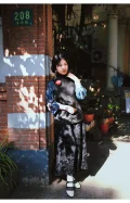 Black and white 1920s Qipao dress goat leather shoes with classic cutout details, worn with a traditional Republican era outfit by a model standing at Duolun Road brick wall, showing vintage cheongsam styling.