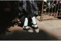 Black and white 1920s Qipao dress goat leather shoes with cutout straps, worn with a black vintage cheongsam, captured in natural outdoor light for retro cheongsam styling.