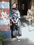 Black and white 1920s Qipao dress goat leather shoes with hollow out straps, paired with a traditional Republican era outfit, worn by a model leaning against a brick wall outdoors.