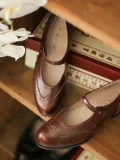 Warm brown Margarita 1920s vintage schoolgirl leather Qipao Mary Jane shoes with classic brogue detailing, placed on a vintage wooden bookshelf for nostalgic retro feel.