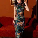 Elegant woman in a Chinese vintage floral silk qipao dress, front view highlighting the traditional mandarin collar, frog closure, and bodycon silhouette against a retro red sofa.