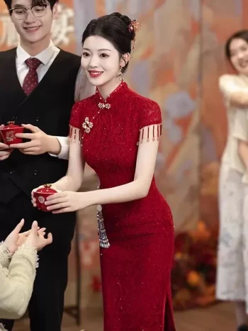 Woman serving tea in a wine red floral lace wedding cheongsam dress, traditional chinese cheongsam midi dress with intricate floral pattern, ideal for tea ceremonies and wedding receptions.