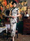 Full-length shot of woman in 1920s Shanghai-style Chinese silk cheongsam with classic ink-wash print, black lace trim, and traditional high collar, exuding old Shanghai charm.